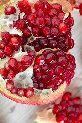 pomegranate seeds on wooden surface