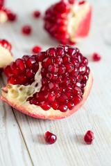 pomegranate seeds on wooden surface