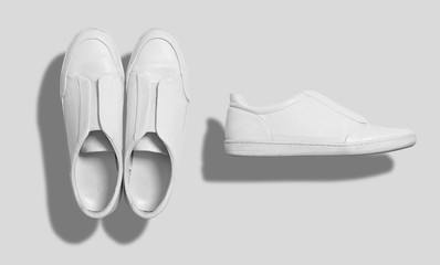 White leather sneaker like casual shoes with flat sole without shoelaces shot from the top and from the side isolated on white