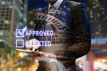 Double exposure businessman hand using digital tablet with check