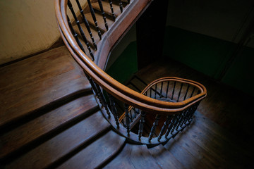 Shape, architecture and perspective. Beautiful old wooden spiral staircase.