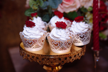 Candy bar, red colour, marsala. Table with wedding cake, sweets, candies, dessert, pops.