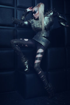 Blond woman in steel armor posing 