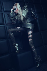 Fototapeta na wymiar Blond woman in steel armor posing 