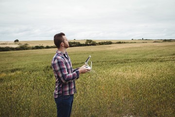 Farmer using agricultural device while examining in field