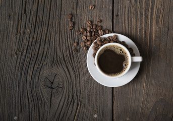 Cup of coffee with brown sugar on a wooden table.