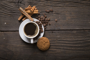 Cup of coffee with brown sugar on a wooden table.