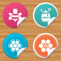 Round stickers or website banners. Honey icon. Honeycomb cells with bees symbol. Sweet natural food signs. Circle badges with bended corner. Vector