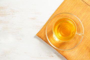Green tea in glass cup on the wooden background