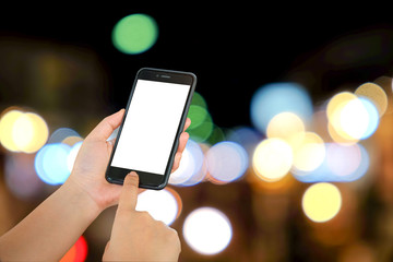 Smart phone in hand on light blurred background.