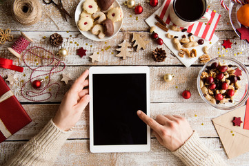 Christmas composition. Man holding tablet. Studio shot.