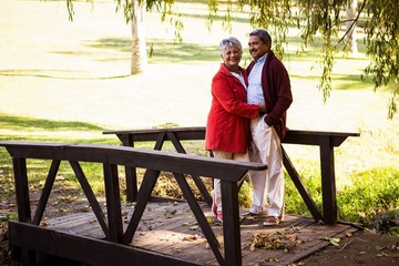 Couple embracing while standing on footbridge