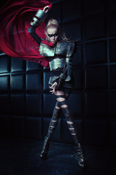 Blond woman in steel armor posing 