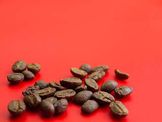 Brown coffee beans, Placed on a red background.