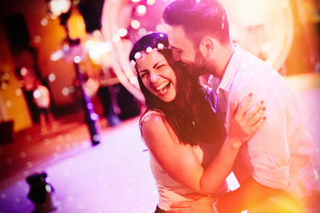 Happy couple hugging and smiling at festival