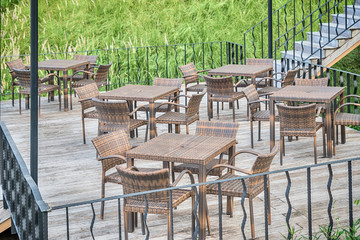 The wood table on natural outdoor of a restaurant with tree and