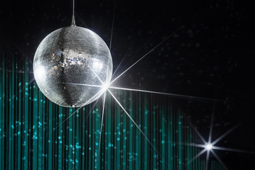 Party disco ball with stars in nightclub with striped turquoise and black walls lit by spotlight,...