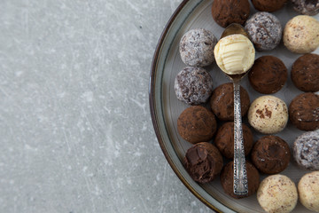 Assorted chocolate truffles with cocoa powder, coconut and chopp