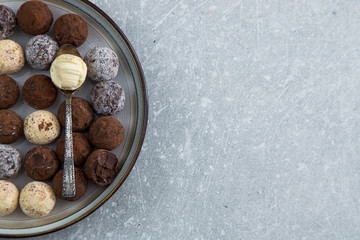 Assorted chocolate truffles with cocoa powder, coconut and chopp
