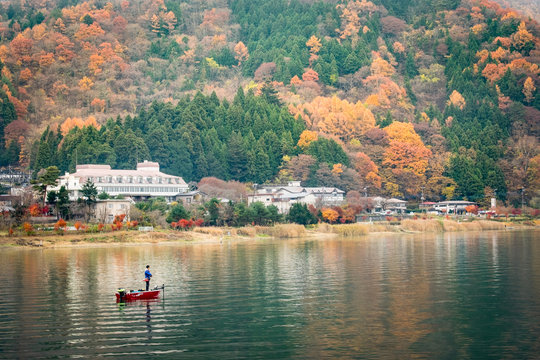 A man fishing on the little boat in Beautiful lake
