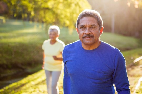 Mature Man Walking In A Park