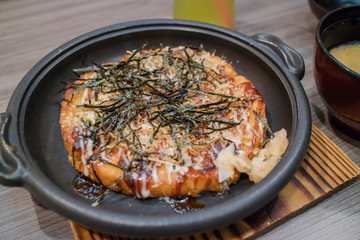 Okonomiyaki Japanese Traditional Pizza on hot plate