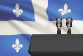 Pulpit and two microphones with Canadian province flag on background - Quebec