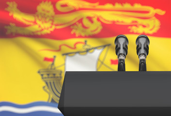 Pulpit and two microphones with Canadian province flag on background - New Brunswick