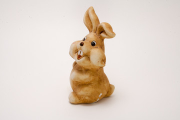 ceramic figurine brown rabbit isolated on white background
