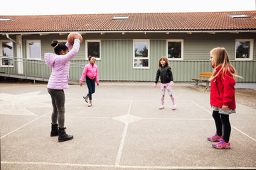High angle view of children playing with ball in school playground