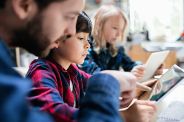 Teacher with pupils using digital tablet