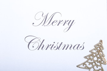 Fototapeta na wymiar Text merry christmas on paper with gold decoration