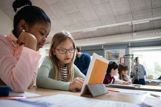 Pupils in classroom using tablet