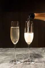 Champagne pouring in two glasses
