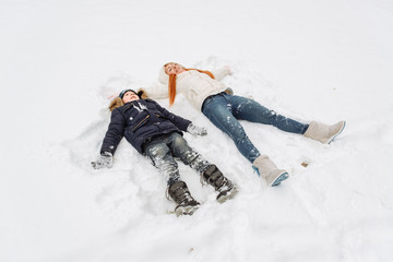 mother and son having fun in the snow wonderful winter day