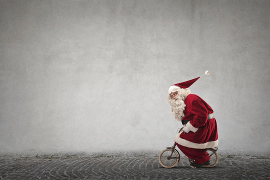 Santa Claus riding a small bike