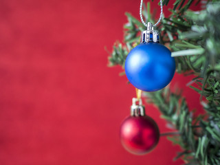 Blue and red christmas ball hang on Christmas tree with red blur