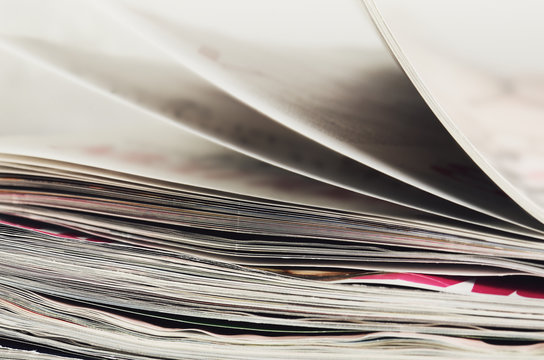 close-up stack of magazines to turn pages