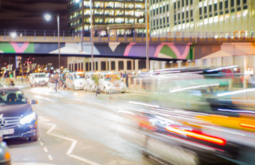 Fototapeta na wymiar City street blurred image for background. Cars, lights and walking people blur