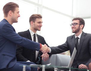 Handshake between businesspeople in a modern office