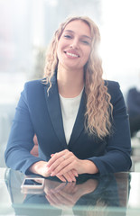 Successful business woman with her staff in background at office