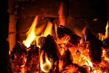 Fire burning inside a brick stove - wood, ash, flames