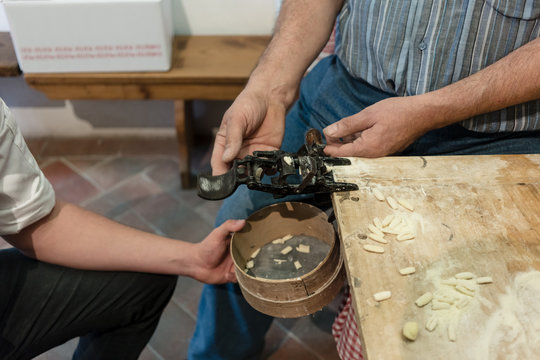 Two men preparing traditional pasta in factory