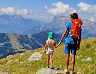 Young man with a kid in mountains