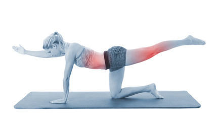 Obraz premium Young woman exercising on mat