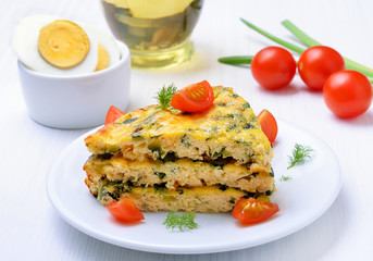 Piece of vegetable omelet with fresh tomatoes