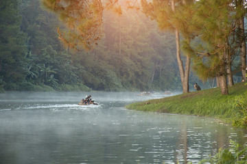 beautiful scenery - bamboo rafting through the mist on the lake in morning at Pang-ung, in Mae Hong Son,Thailand
