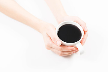 girl holding a cup of black coffee in hand.