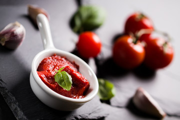 Food ingredients for Italian spaghetti on black stone slate background. Vegetarian version of pasta.