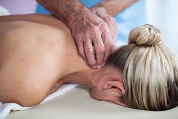 Fototapeta na wymiar Woman receiving neck massage from physiotherapist
